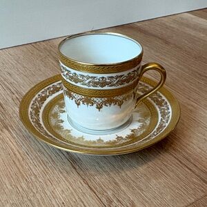Gold and White intricately detailed tea cup.